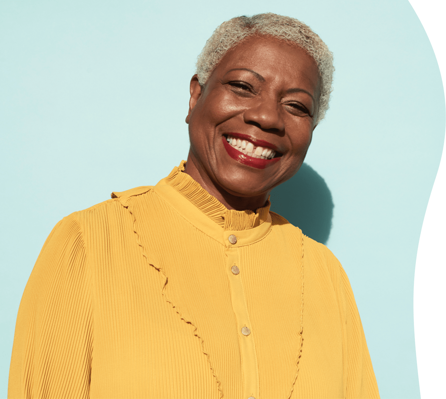 Woman with big smile and yellow blouse